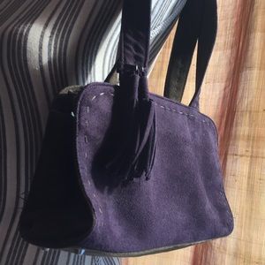 Purple “suede” zipper purse with tassels.